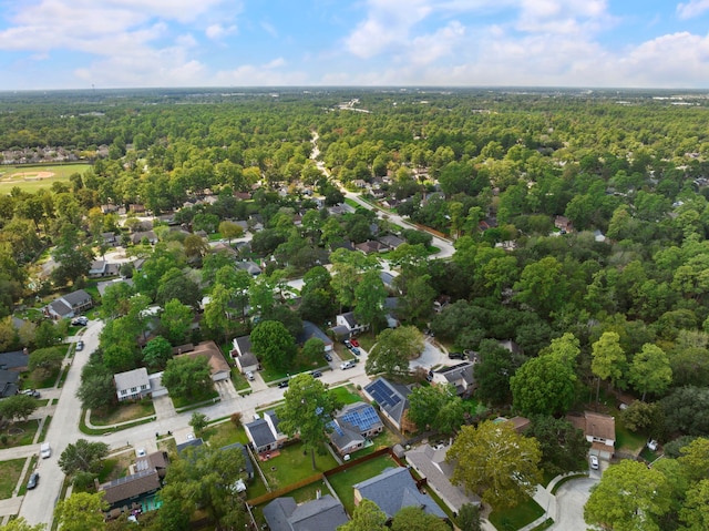 view of property location with a heavily wooded area and nearby suburban area