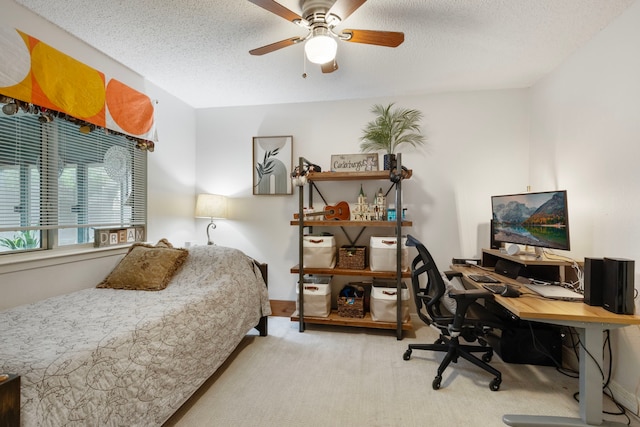 bedroom with carpet, an office area, ceiling fan, and a textured ceiling