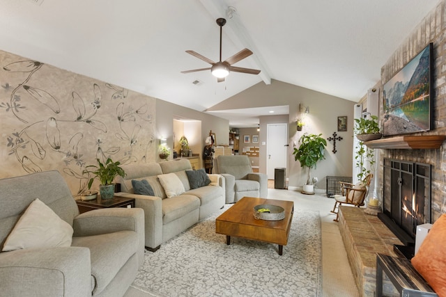 living area with a ceiling fan and a brick fireplace