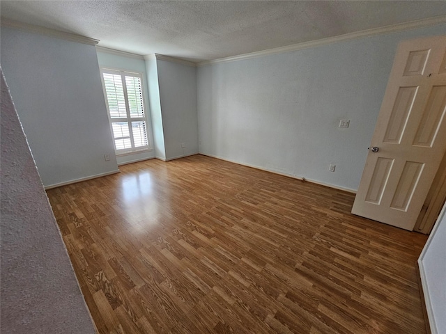 1100 Augusta Dr Unit 42, Houston, TX 77057 - unfurnished room with ornamental molding, wood finished floors, a textured ceiling, and baseboards