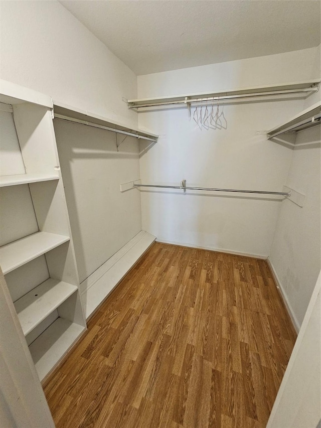 1100 Augusta Dr Unit 42, Houston, TX 77057 - walk in closet featuring wood finished floors