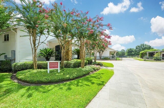 view of front of home featuring fence and driveway