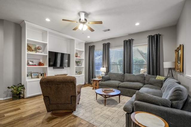 living area with light wood-type flooring, ceiling fan, and recessed lighting