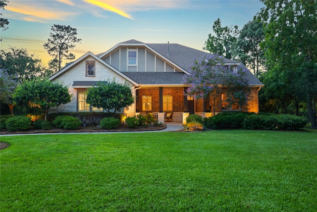5523 Harvest Oak Landing Dr, Spring, TX 77386 - view of front of home featuring a yard, brick siding, a shingled roof, and a porch