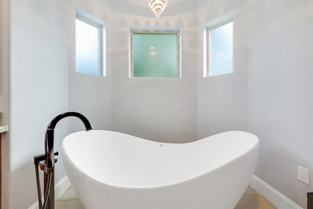 5523 Harvest Oak Landing Dr, Spring, TX 77386 - bathroom with a soaking tub, tile patterned floors, and baseboards