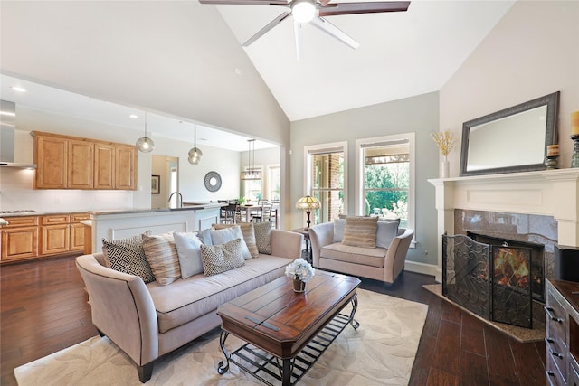 5523 Harvest Oak Landing Dr, Spring, TX 77386 - living room featuring a ceiling fan, high vaulted ceiling, wood-type flooring, a tile fireplace, and recessed lighting