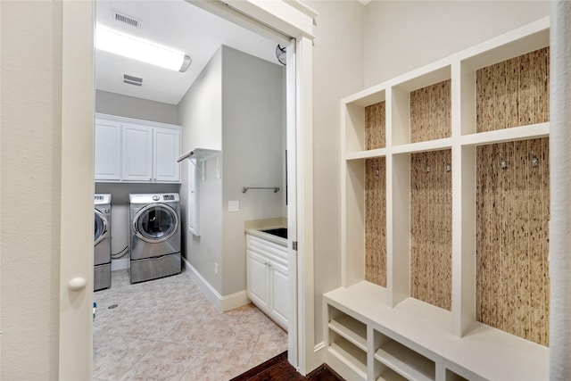 5523 Harvest Oak Landing Dr, Spring, TX 77386 - laundry room with washing machine and dryer, cabinet space, and baseboards