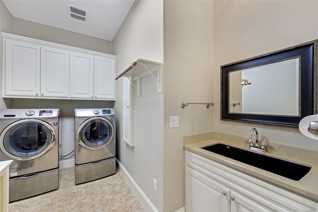 5523 Harvest Oak Landing Dr, Spring, TX 77386 - laundry room with washer and dryer, cabinet space, tile patterned floors, and baseboards