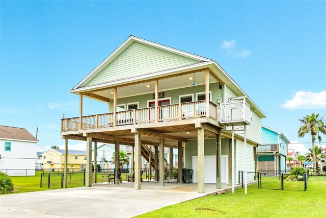4126 Grayson Dr, Galveston, TX 77554 - back of property with a carport, concrete driveway, stairway, an attached garage, and covered porch