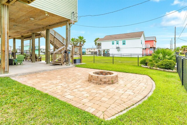 4126 Grayson Dr, Galveston, TX 77554 - view of patio featuring stairway and a fire pit