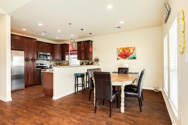 4126 Grayson Dr, Galveston, TX 77554 - dining room featuring dark wood finished floors, plenty of natural light, and recessed lighting