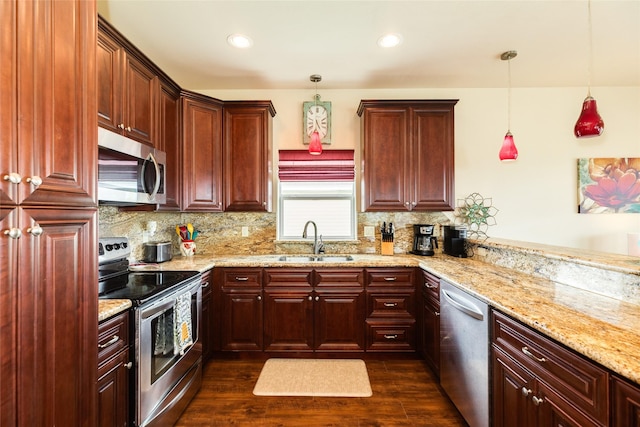 4126 Grayson Dr, Galveston, TX 77554 - kitchen with appliances with stainless steel finishes, a sink, backsplash, dark wood-type flooring, and recessed lighting