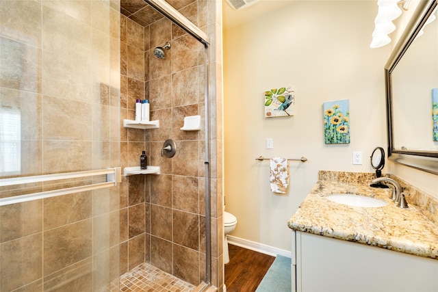 4126 Grayson Dr, Galveston, TX 77554 - bathroom with a stall shower, wood finished floors, vanity, baseboards, and toilet