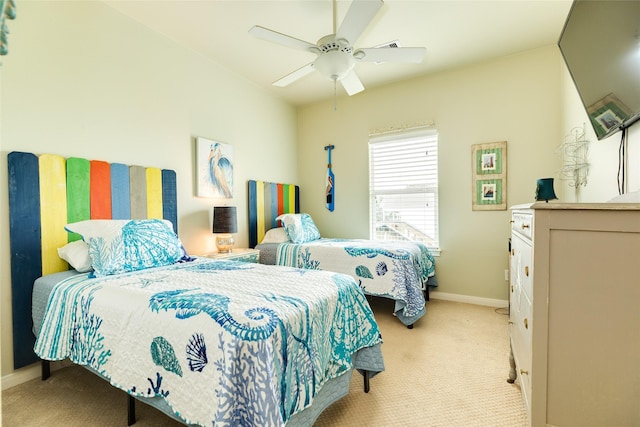 4126 Grayson Dr, Galveston, TX 77554 - bedroom featuring light carpet, baseboards, and a ceiling fan