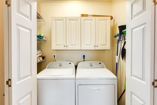 4126 Grayson Dr, Galveston, TX 77554 - washroom with washing machine and dryer and cabinet space