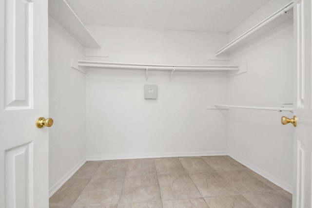 spacious closet featuring light tile patterned floors