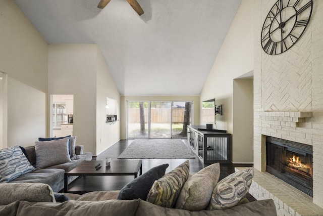 17310 Chaseloch St, Spring, TX 77379 - living area with high vaulted ceiling, a brick fireplace, a ceiling fan, and dark wood finished floors