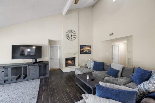 17310 Chaseloch St, Spring, TX 77379 - living room featuring high vaulted ceiling, a brick fireplace, dark wood-style flooring, beamed ceiling, and a ceiling fan