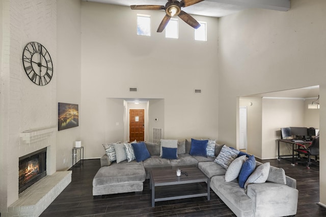 17310 Chaseloch St, Spring, TX 77379 - living area featuring a ceiling fan, a high ceiling, dark wood-style flooring, and a brick fireplace
