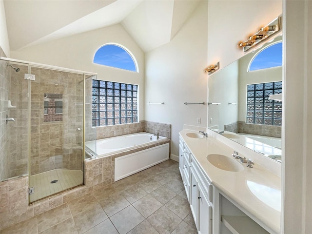 3701 Main Plaza Dr, Houston, TX 77025 - bathroom featuring tile patterned flooring, a bath, a stall shower, double vanity, and high vaulted ceiling