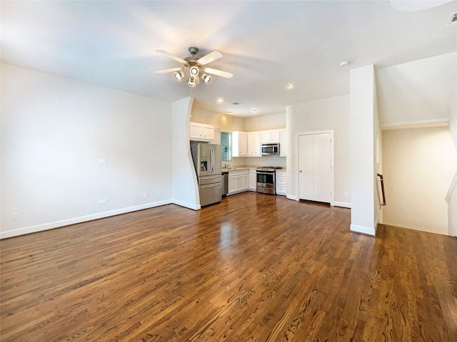 3701 Main Plaza Dr, Houston, TX 77025 - unfurnished living room featuring ceiling fan, dark wood-type flooring, and baseboards