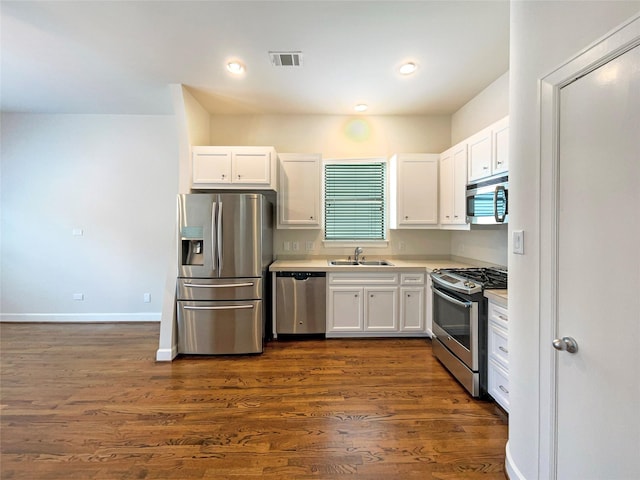 3701 Main Plaza Dr, Houston, TX 77025 - kitchen featuring stainless steel appliances, a sink, white cabinets, and recessed lighting