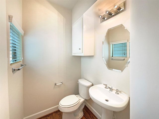 3701 Main Plaza Dr, Houston, TX 77025 - half bath featuring toilet, baseboards, wood finished floors, a sink, and healthy amount of natural light