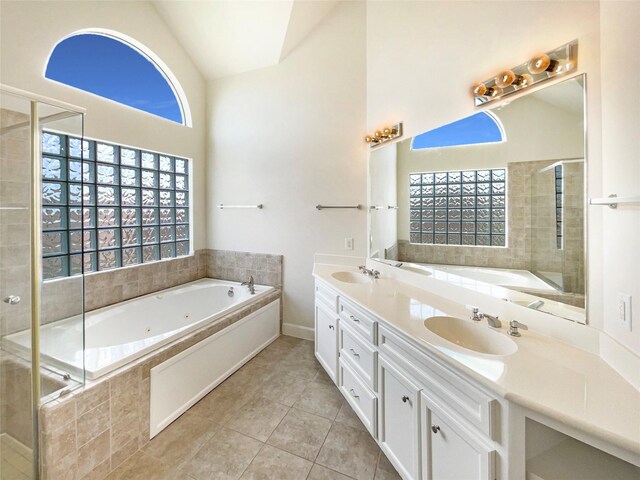 3701 Main Plaza Dr, Houston, TX 77025 - bathroom with tile patterned floors, vaulted ceiling, a jetted tub, double vanity, and a tile shower
