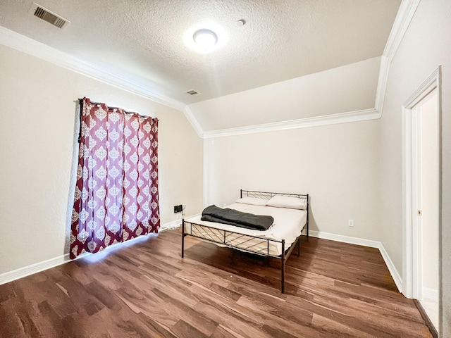 5715 Ladonia St, Arcola, TX 77583 - bedroom featuring ornamental molding, wood finished floors, a textured ceiling, baseboards, and vaulted ceiling