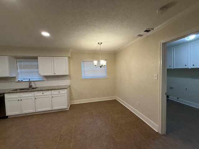 kitchen featuring a sink, crown molding, baseboards, light stone counters, and a chandelier