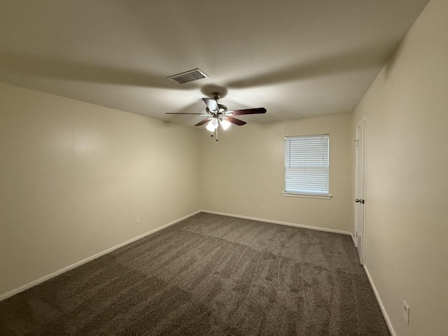 empty room with dark carpet, baseboards, and ceiling fan