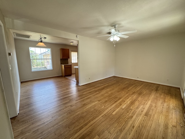 216 Gale St, Houston, TX 77009 - unfurnished room featuring wood finished floors, ceiling fan, and baseboards