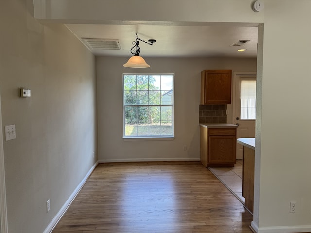 216 Gale St, Houston, TX 77009 - unfurnished dining area with light wood finished floors and baseboards