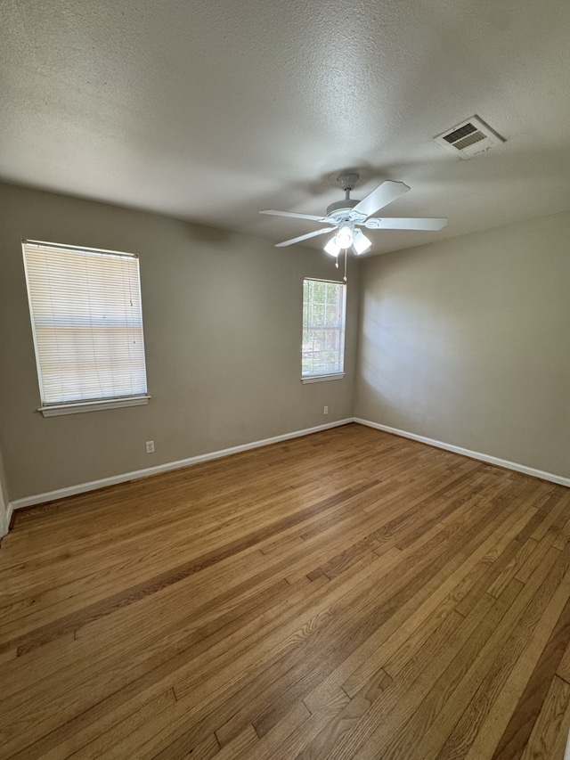216 Gale St, Houston, TX 77009 - unfurnished room featuring ceiling fan, wood finished floors, a textured ceiling, and baseboards