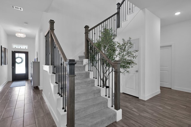 2807 Kingly Pine Trl, Conroe, TX 77385 - entryway with wood finished floors, baseboards, stairway, a chandelier, and a high ceiling