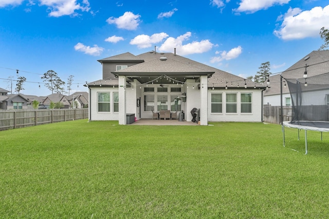 2807 Kingly Pine Trl, Conroe, TX 77385 - rear view of house with a trampoline, a patio area, and roof with shingles