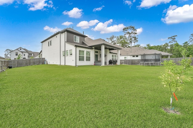2807 Kingly Pine Trl, Conroe, TX 77385 - back of house with a trampoline