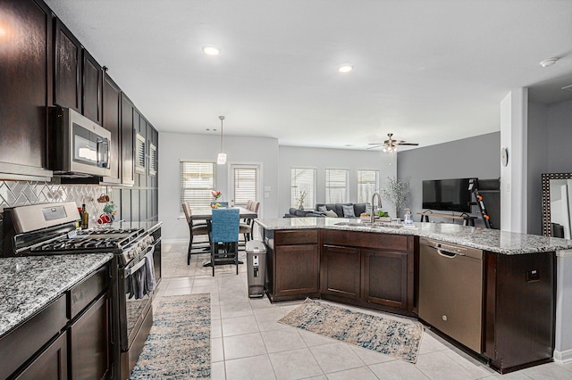 10906 Granite Chief Dr, Rosharon, TX 77583 - kitchen with stainless steel appliances, a sink, open floor plan, recessed lighting, and a ceiling fan