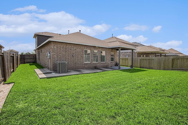 10906 Granite Chief Dr, Rosharon, TX 77583 - rear view of house featuring a patio, brick siding, central AC, and a shingled roof