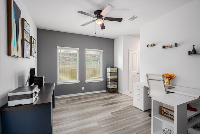 10906 Granite Chief Dr, Rosharon, TX 77583 - home office featuring a ceiling fan, light wood-style flooring, and baseboards