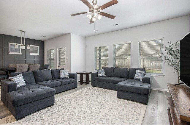 10906 Granite Chief Dr, Rosharon, TX 77583 - living area featuring wood finished floors, a ceiling fan, and baseboards
