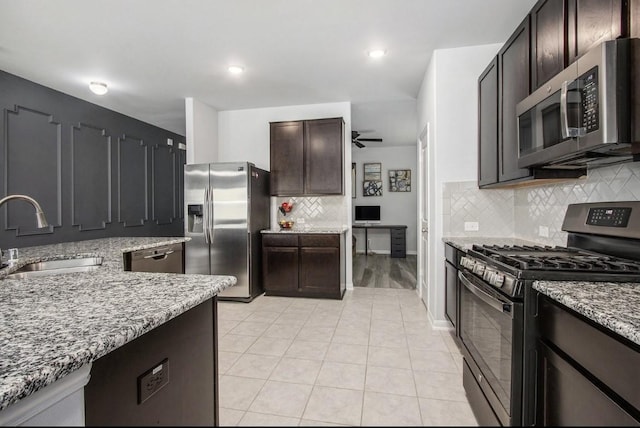 10906 Granite Chief Dr, Rosharon, TX 77583 - kitchen with stainless steel appliances, a sink, ceiling fan, light stone counters, and recessed lighting