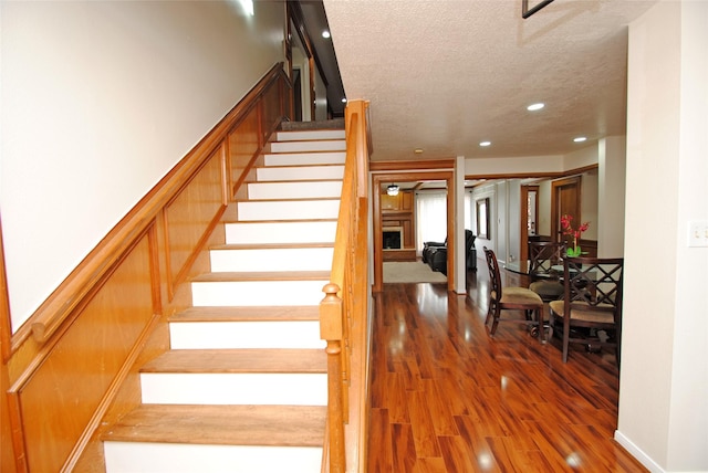 15007 Pebble Bend Dr, Houston, TX 77068 - stairway featuring a textured ceiling, recessed lighting, and wood finished floors