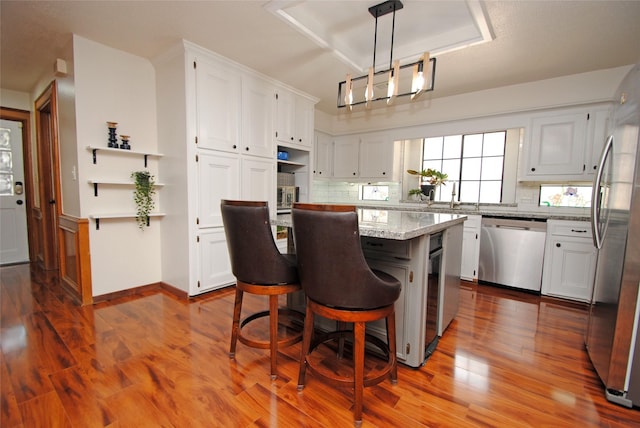 15007 Pebble Bend Dr, Houston, TX 77068 - kitchen featuring stainless steel appliances, a kitchen island, dark wood-type flooring, and white cabinetry