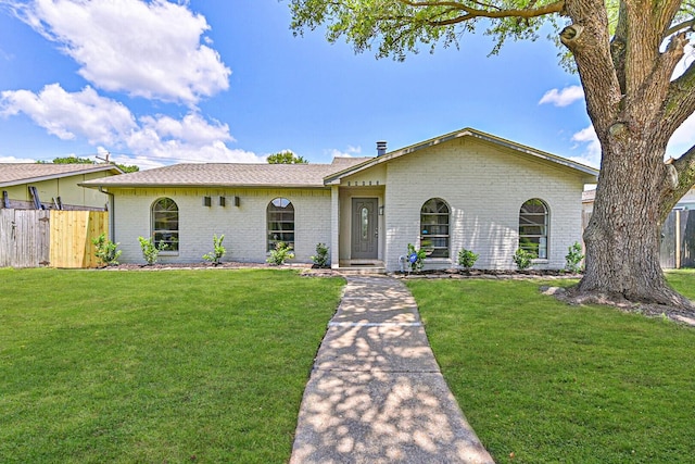 ranch-style house featuring brick siding and a shingled roof