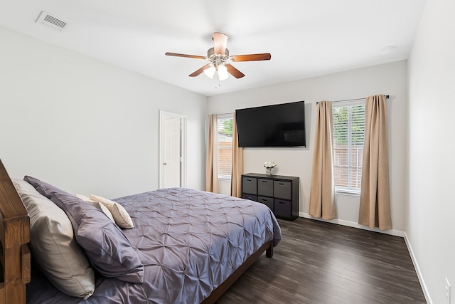 8038 Villa Lago Ln, Houston, TX 77070 - bedroom with multiple windows, dark wood-type flooring, baseboards, and a ceiling fan