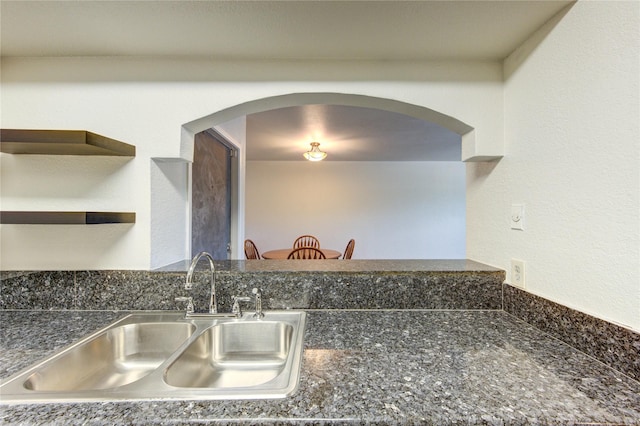 kitchen view of a sink and arched walkways