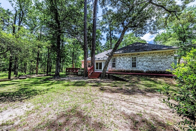 304 Inverness St, Huntsville, TX 77340 - view of grassy yard with a wooden deck