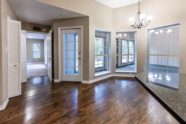 304 Inverness St, Huntsville, TX 77340 - unfurnished dining area featuring a chandelier, wood finished floors, and baseboards