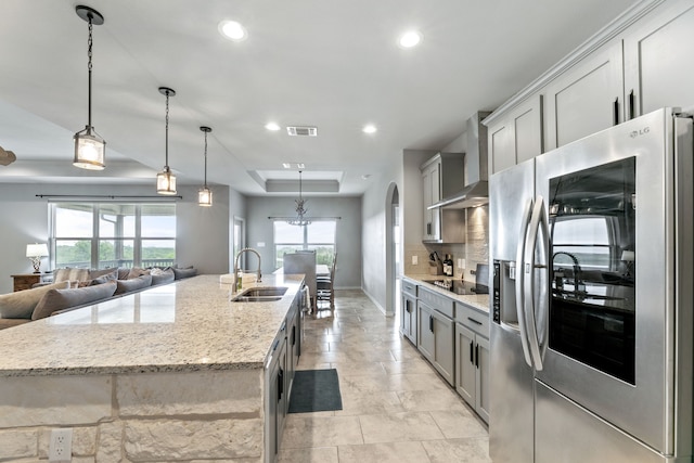 192 Primrose Path, Canyon Lake, TX 78133 - kitchen featuring stainless steel fridge, wall chimney exhaust hood, a sink, recessed lighting, and a large island